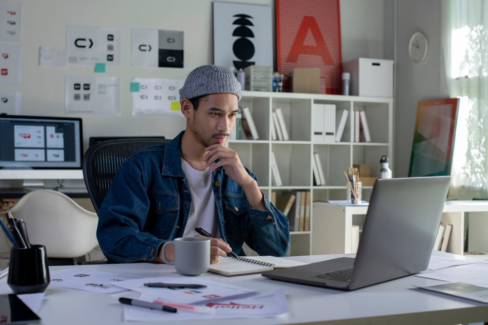 Asian man web designer working in office.